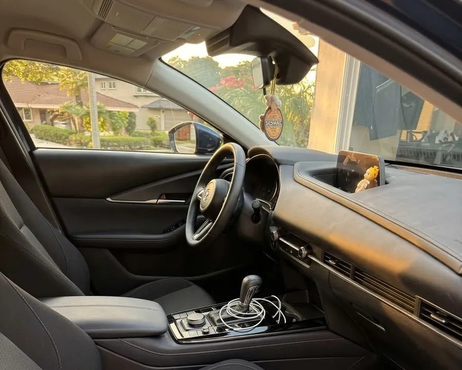 The same front cabin after detailing: console cleared, dash and door card wiped down, vents and screen cleaned
