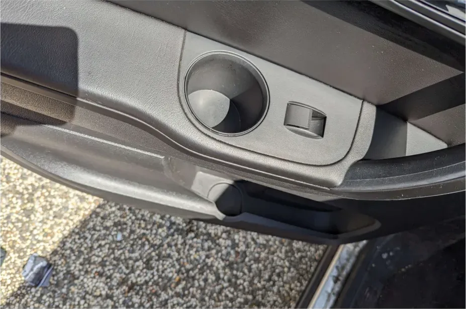 The same cupholder after: residue and stains gone, plastic clean and matte