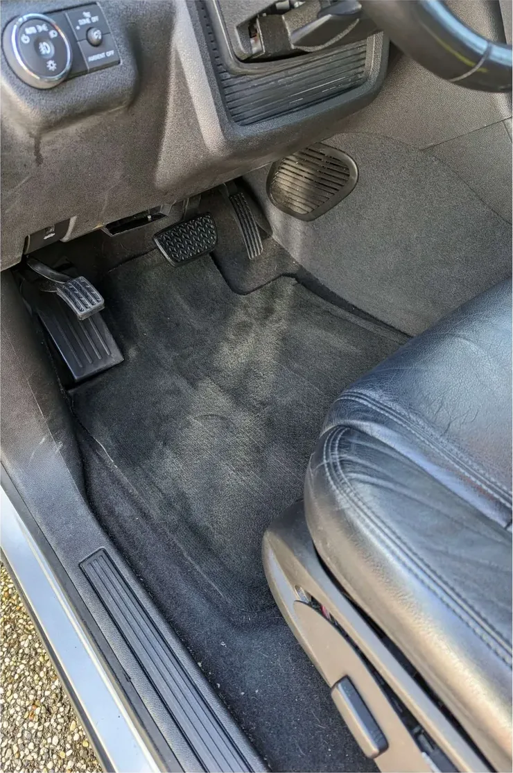 The same footwell after: carpet extracted, mat clean, pedals and sill plate wiped down
