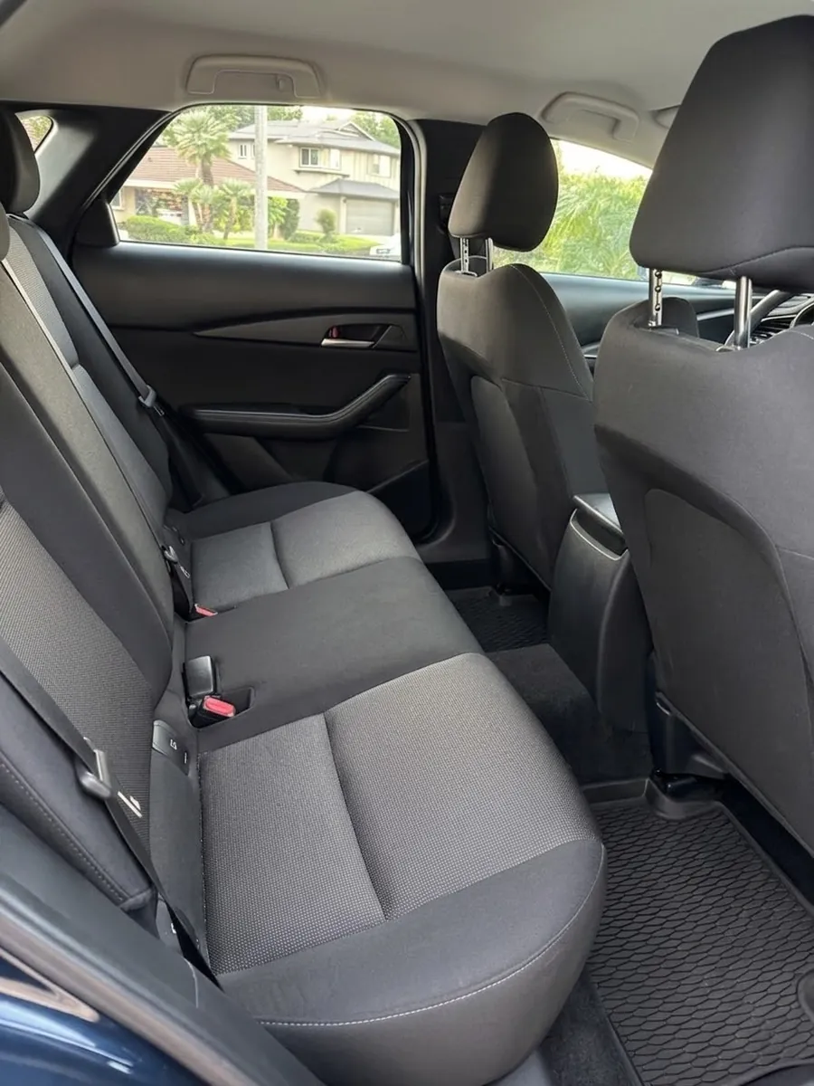 The same back seat after an Interior Reset: cloth extracted, seams and crevices cleared, floor mat and door card wiped down