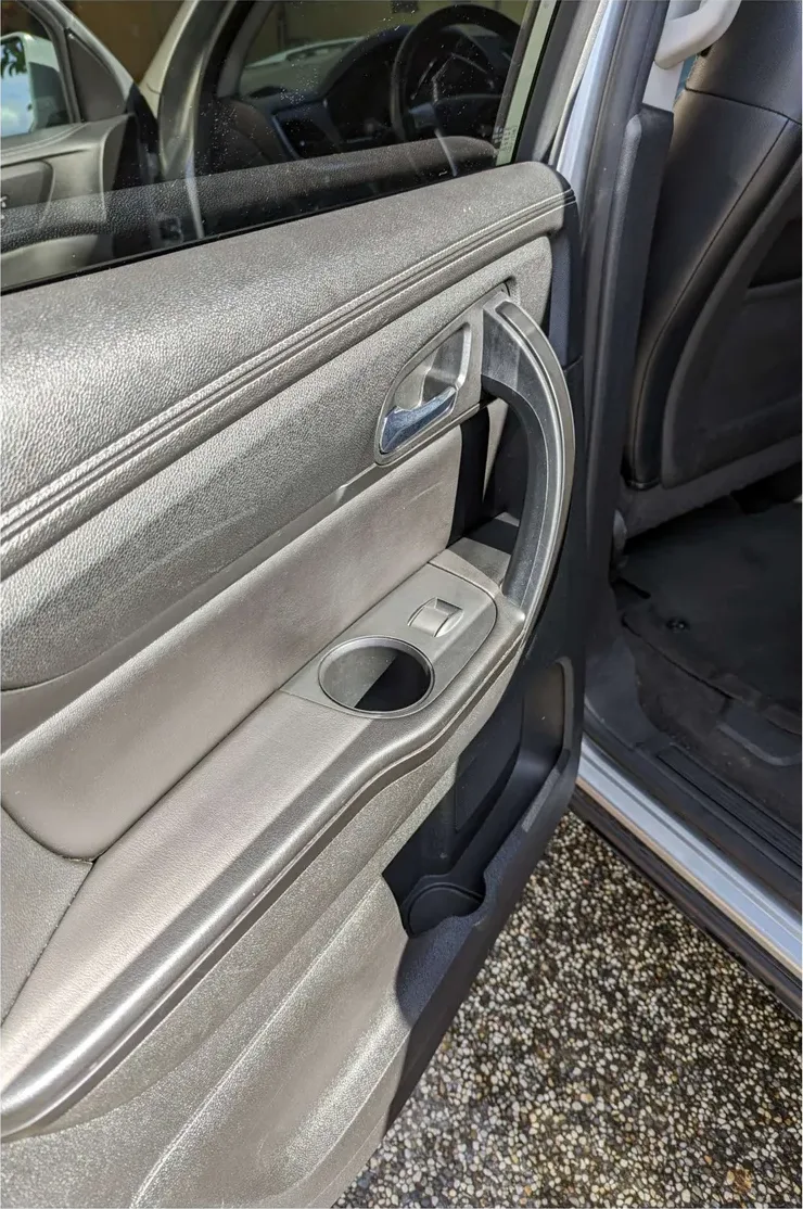 The same rear door after: drip stains gone, cupholder and pocket clean