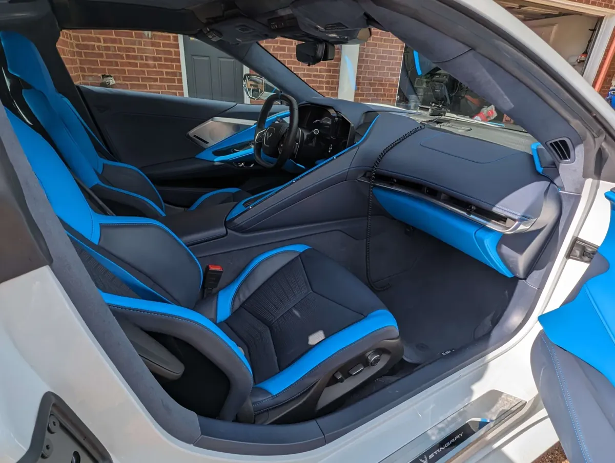 The Corvette passenger side after detailing: blue leather seat, dash and carpet clean