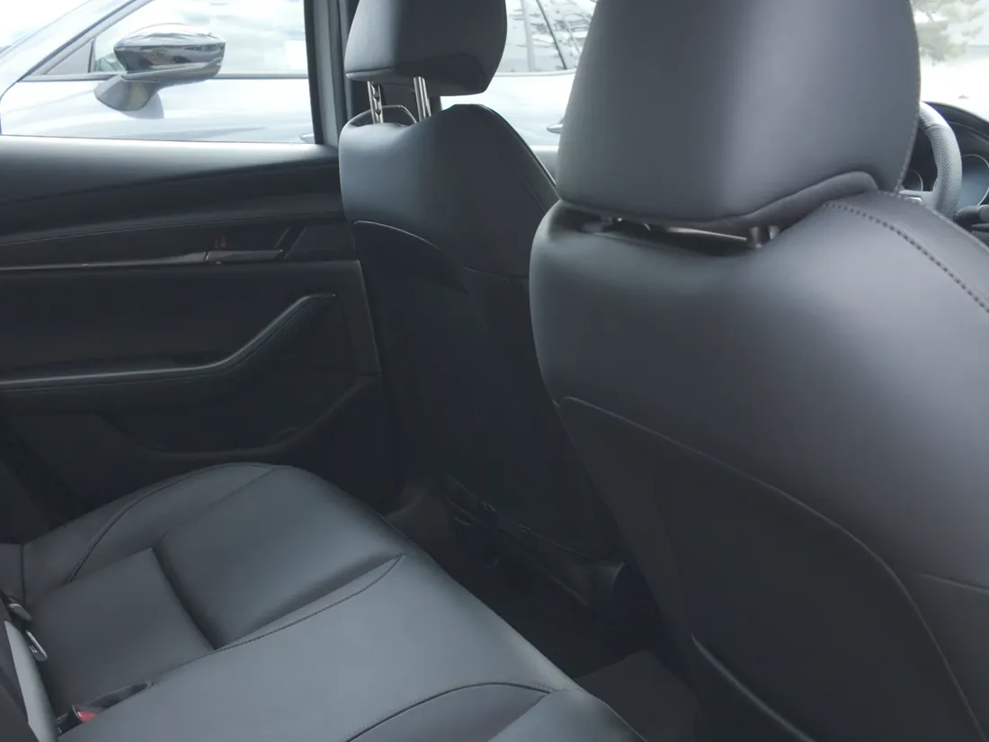 A finished car cabin after an Interior Reset: black leather seats, door cards and headliner cleaned, finished matte with no greasy shine
